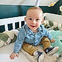 Gauthier a rejoint le concours — aidez-le/la à gagner de superbes lots ! baby, child, clothing, cozy, crib, cute, denim_shirt, furniture, happy, head, indoors, infant, khaki_pants, mobile, person, plush_toys, sitting, smiling, sneakers, soft_toys