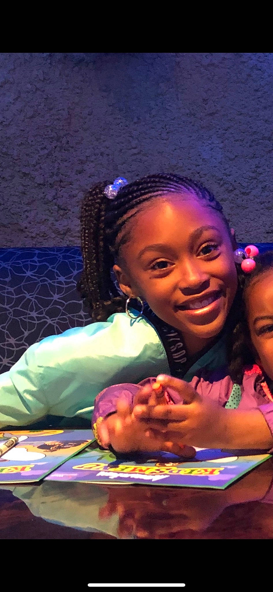 Kennia is registered to the contest to win money with this photo: abdomen, cheek, child, entertainment, event, fun, hair, happy, indoor_games_and_sports, jewellery, joy, leisure, music_artist, performance, performance_art, performing_arts, person, purple, room, smile