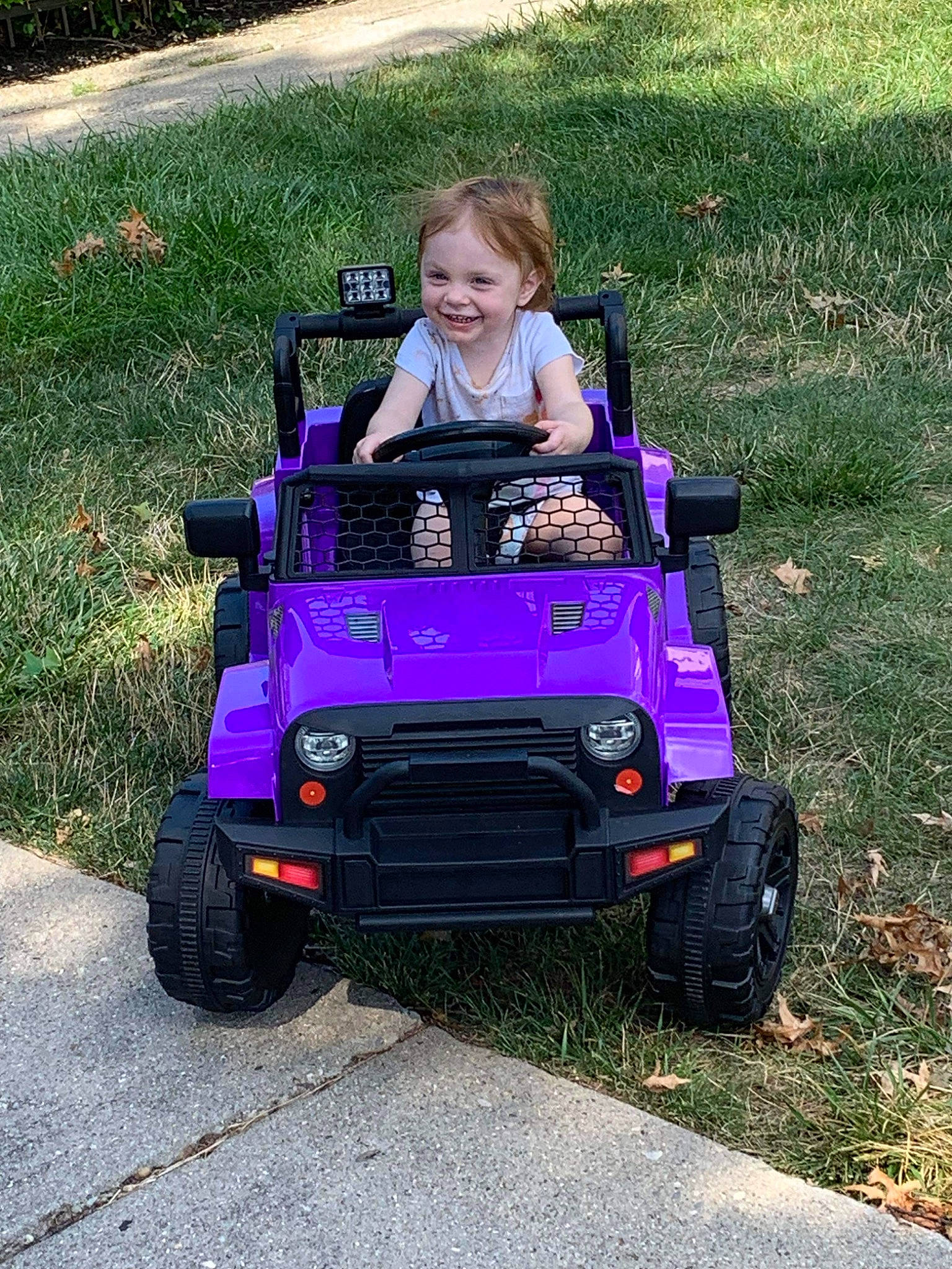 Kaleah joined the competition — help win amazing prizes! auto_part, automotive_design, automotive_exterior, automotive_lighting, automotive_tire, bumper, car, fender, grass, hood, joy, kit_car, magenta, motor_vehicle, person, purple, riding_toy, smile, tire, toddler