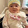 Ezra joined the competition — help win amazing prizes! baby, infant, knitted_hat, bib, clothing, face, person, indoor, carpet, toy, door, wall, hand, sleeve, pink, white, cute, expression, child, home