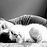 Muffin joined the competition — help win amazing prizes! cat, person, pet, black_and_white, portrait, close_up, fluffy, white_cat, lying_down, relaxed, cuddling, companion, indoor, carpet, floor, human_face, eye, whiskers, soft_lighting, photography