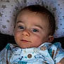 Noah participe au concours pour gagner de l'argent avec cette photo : baby, infant, face, pillow, stars, clothing, pattern, animal_print, cute, child, portrait, looking_at_camera, lying_down, young, soft_lighting, smile, button, short_sleeve, indoors, skin