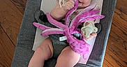 Isla is registered to the contest to win money with this photo: baby, infant, smiling, plush_toy, octopus_toy, pacifier, baby_rocker, gray_fabric, wooden_floor, happy, cute, child, sitting, indoors, young, human, toy, legs, feet, face