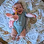 Emilia joined the competition — help win amazing prizes! baby, infant, smiling, toy, plush_bunny, blanket, animal_print, blue_onesie, wooden_sign, four_months, carpet, foot, cute, happy, lying_down, child, indoors, playful, baby_milestone, portrait