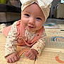Elyna participe au concours pour gagner de l'argent avec cette photo : baby, smiling, headband, pink_clothing, play_mat, indoor, child, infant, cute, happy, face, hands, crawling, patterned_clothing, home, floor, colorful, portrait, person, young_child
