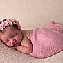 newborn, baby, sleeping, pink_blanket, flower_headband, soft_texture, cozy, resting, infant, cute, peaceful, portrait, wrapped, closeup, skin, head, hands, lying_down, indoors, blanket