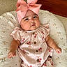 baby, infant, pink_bow, headband, cherry_pattern, cute, clothing, cushion, floral, quilted, indoors, wood_floor, expression, face, skin, arm, legs, sitting, child, portrait