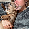 blanket, close_up, comfort, cozy, cuddle, dog, earrings, face, french_bulldog, fur, hand, indoor, love, nap, person, pet, portrait, relaxation, sleeping, warmth