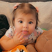 Galilea joined the competition — help win amazing prizes! baby, blanket, child, closeup, couch, cute, eyes, face, girl, hair_clips, indoor, infant, person, playful, plush_toy, portrait, smiling, soft, tongue, young