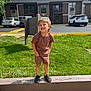 Kayson joined the competition — help win amazing prizes! child, boy, standing, smiling, outdoor, grass, building, apartment, car, parking_lot, concrete, wood, sunlight, casual_clothing, shorts, tshirt, black_shoes, happy, daytime, nature