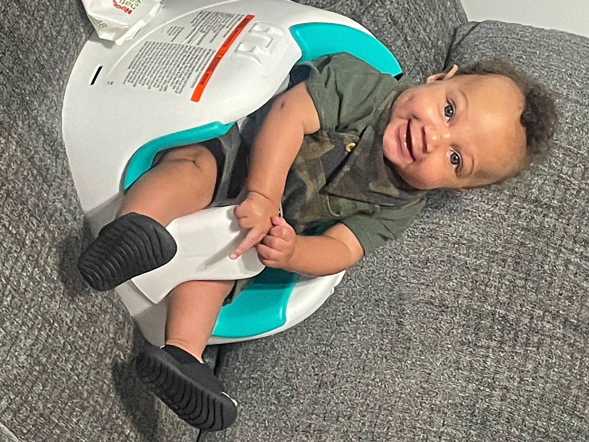 Korbyn is registered to the contest to win money with this photo: baby, baby_products, baby_toddler_clothing, child, comfort, elbow, flooring, foot, fun, grass, human_leg, knee, leg, leisure, person, sitting, sock, sportswear, t_shirt, thigh