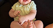 Hazel is registered to the contest to win money with this photo: baby, smiling, happy, infant, couch, legs, person, child, skin, clothing, sitting, indoor, cute, expression, portrait, human, face, barefoot, joy, comfort