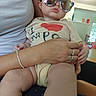 Hazel joined the competition — help win amazing prizes! baby, child, sunglasses, person, adult, hand, arm, indoor, home, furniture, reflection, shirt, sitting, skin, casual_clothing, bracelet, ring, floor, window, light