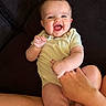 Hazel is registered to the contest to win money with this photo: baby, child, clothing, couch, cute, eyes, face, fingers, hand, happy, indoors, infant, joy, legs, mouth, person, playful, sitting, skin, smiling