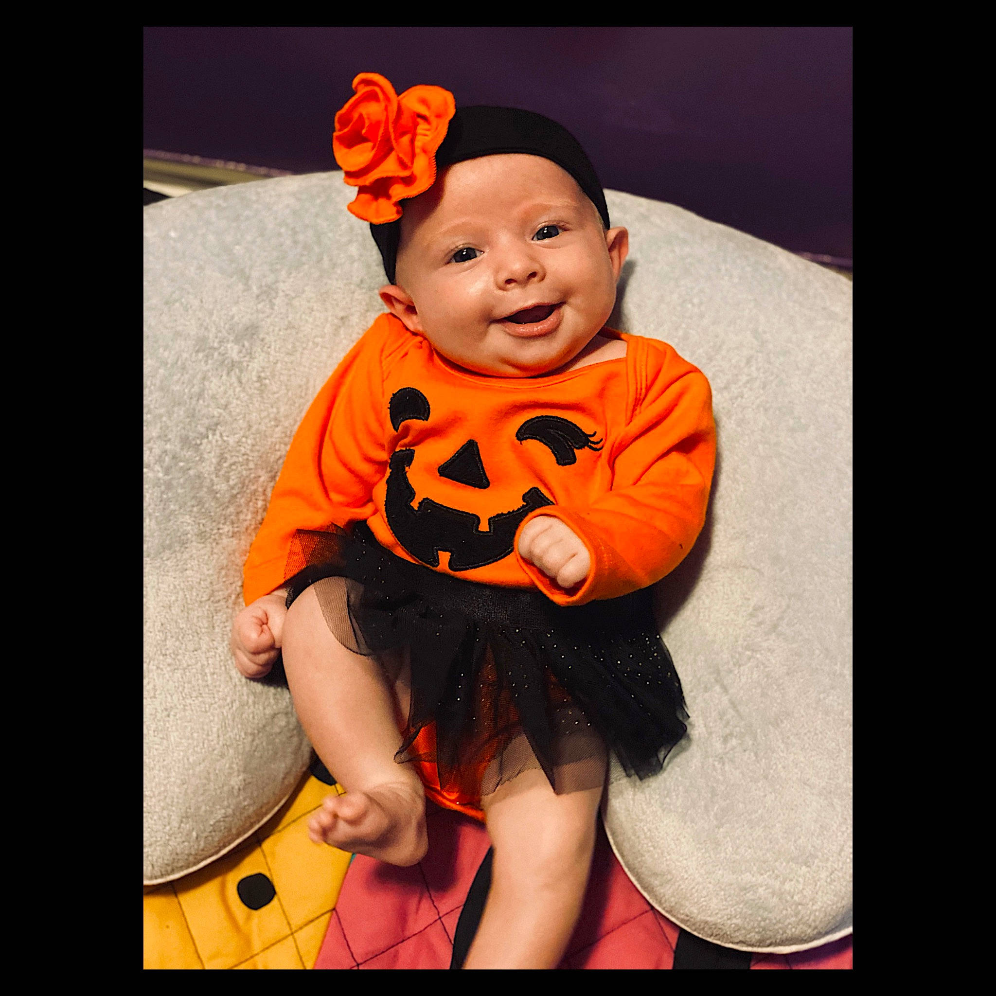 Sally is registered to the contest to win money with this photo: baby, baby_toddler_clothing, cheek, child, costume, ear, face, hair_accessory, happy, head, headgear, headwear, joy, orange, person, photo_shoot, photography, plant, smile, t_shirt