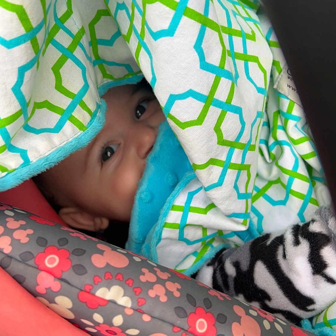 Genevieve is registered to the contest to win money with this photo: baby, baby_products, baby_toddler_clothing, cat, child, comfort, design, facial_expression, felidae, hand, human_leg, linens, mouth, neck, pattern, sitting, sleeve, textile, toddler, whiskers