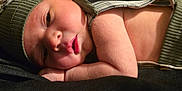 Aiden is registered to the contest to win money with this photo: baby, beanie, bodypart, bonnet, cap, clothing, face, finger, glove, hand, hat, head, hood, knitwear, newborn, person, photography, portrait, sleeping, sweater