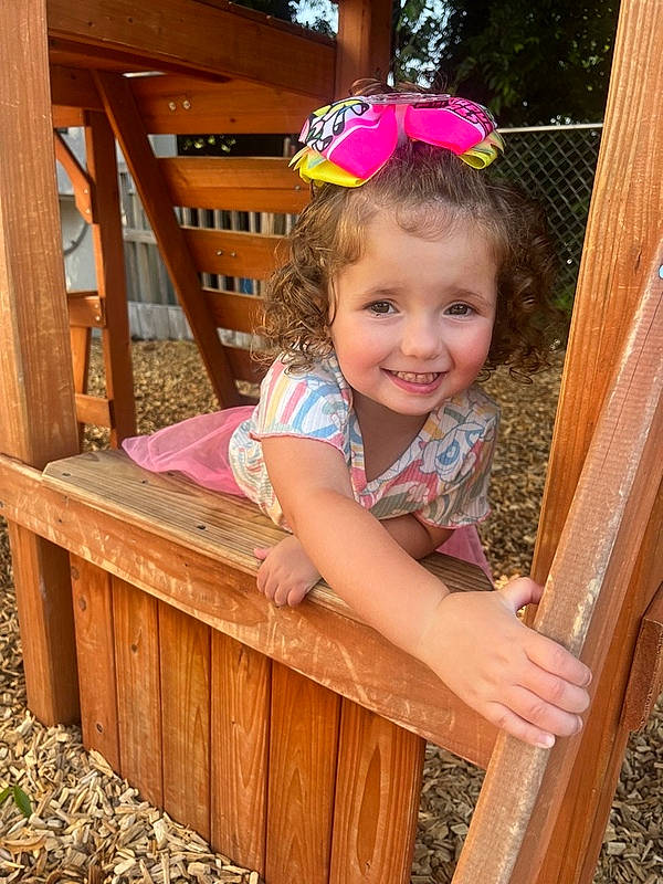 Ellagrace is registered to the contest to win money with this photo: baby, baby_toddler_clothing, child, eye, fun, grass, happy, hardwood, joy, leisure, magenta, outdoor_play_equipment, pattern, person, pink, play, shorts, skin, smile, toddler