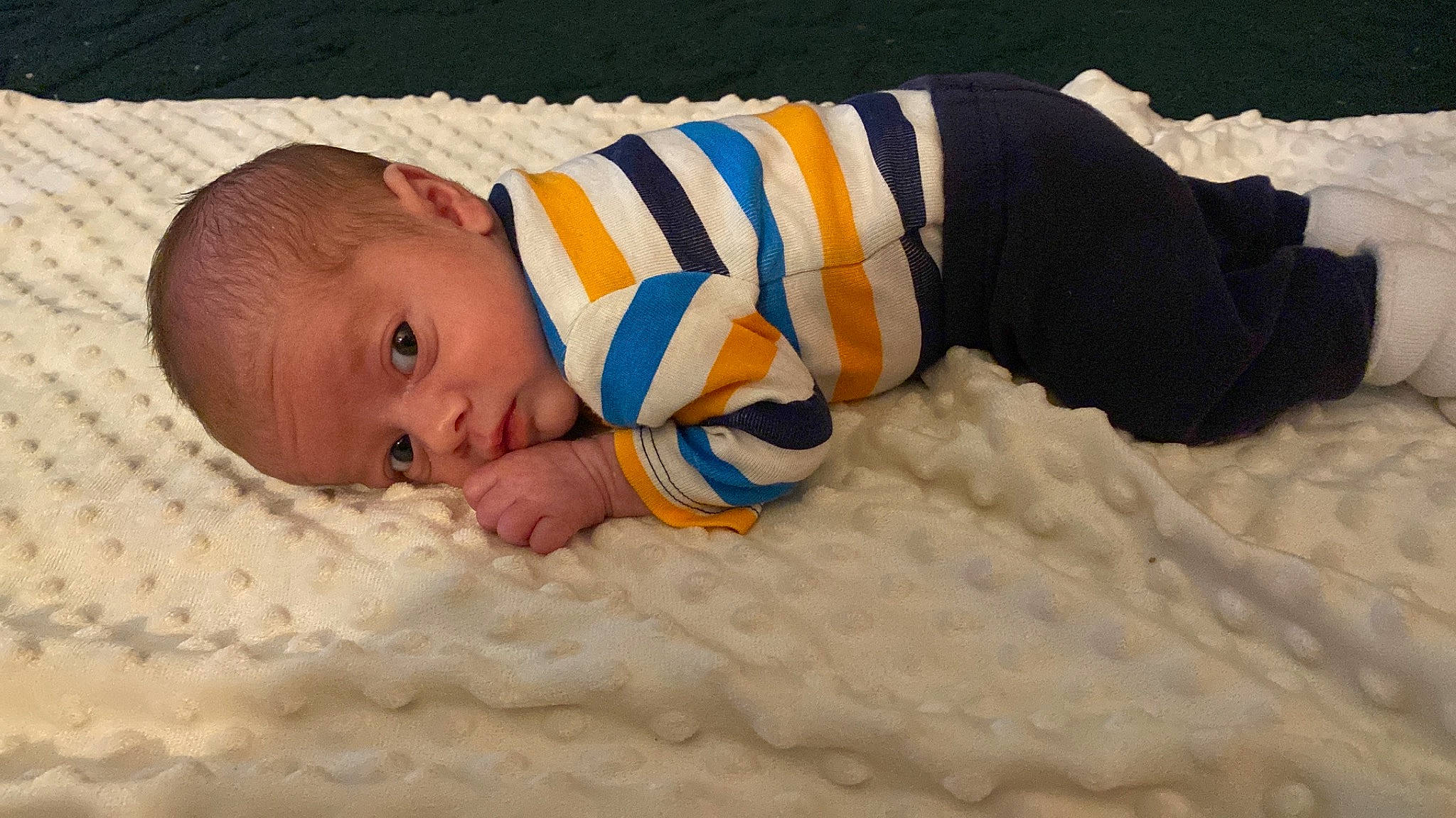 Kane is registered to the contest to win money with this photo: baby, baby_products, baby_sleeping, baby_toddler_clothing, bedtime, cheek, child, comfort, flooring, grass, headgear, human_body, linens, pattern, person, portrait_photography, sleep, sleeve, toddler, wood