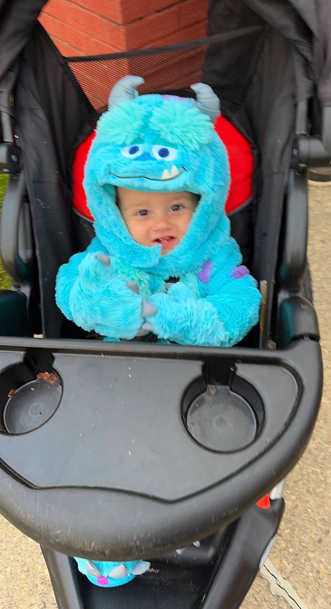 Kane is registered to the contest to win money with this photo: automotive_design, automotive_exterior, automotive_lighting, baby, baby_carriage, baby_products, baby_toddler_clothing, cap, child, electric_blue, eye, fun, headwear, leisure, motor_vehicle, person, public_space, recreation, sitting, skin