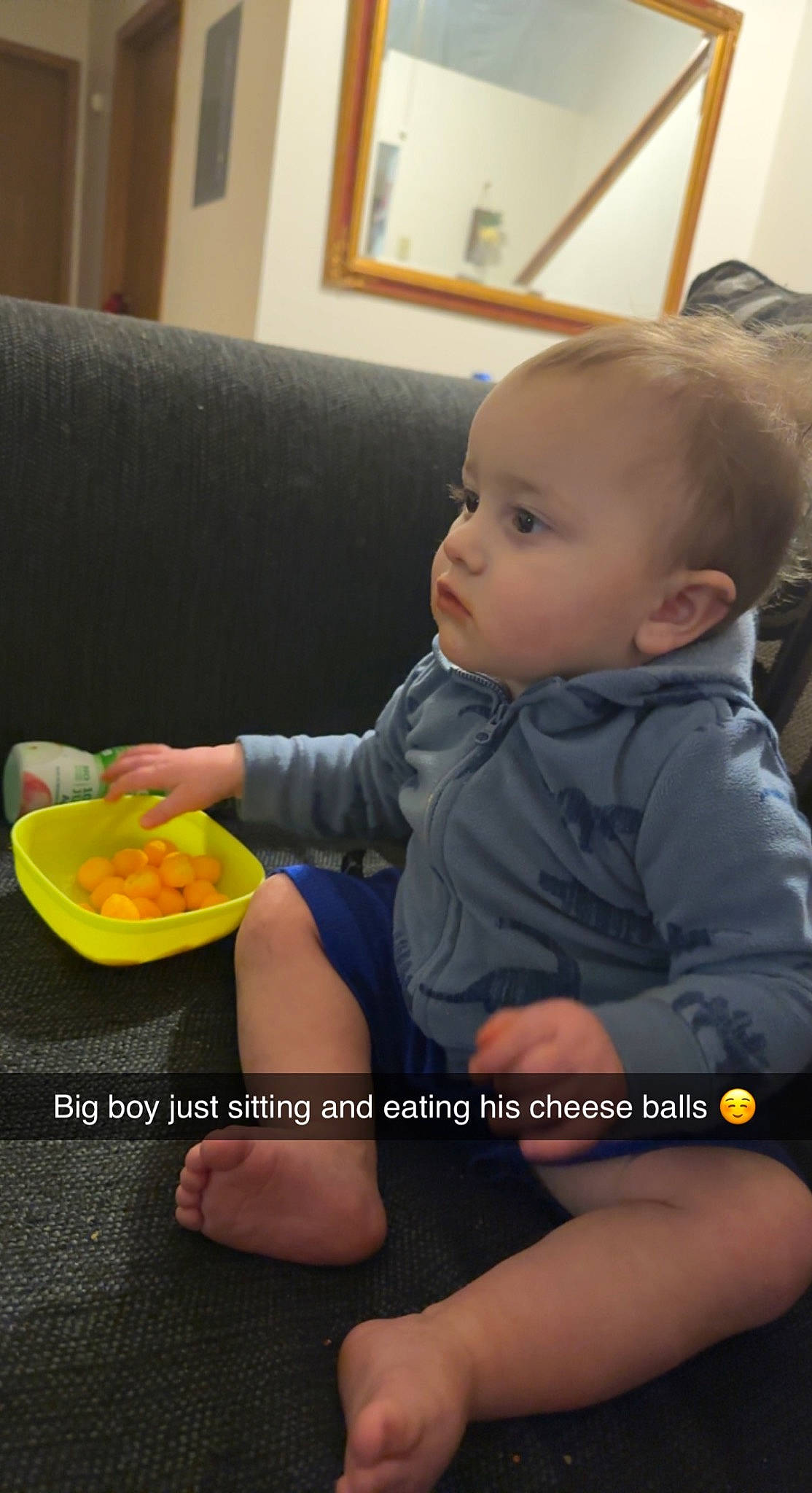 Kane is registered to the contest to win money with this photo: baby, baby_toddler_clothing, child, comfort, comfort_food, couch, cuisine, dish, finger, food, fruit, fun, junk_food, person, picture_frame, recipe, sitting, skin, sleeve, tableware