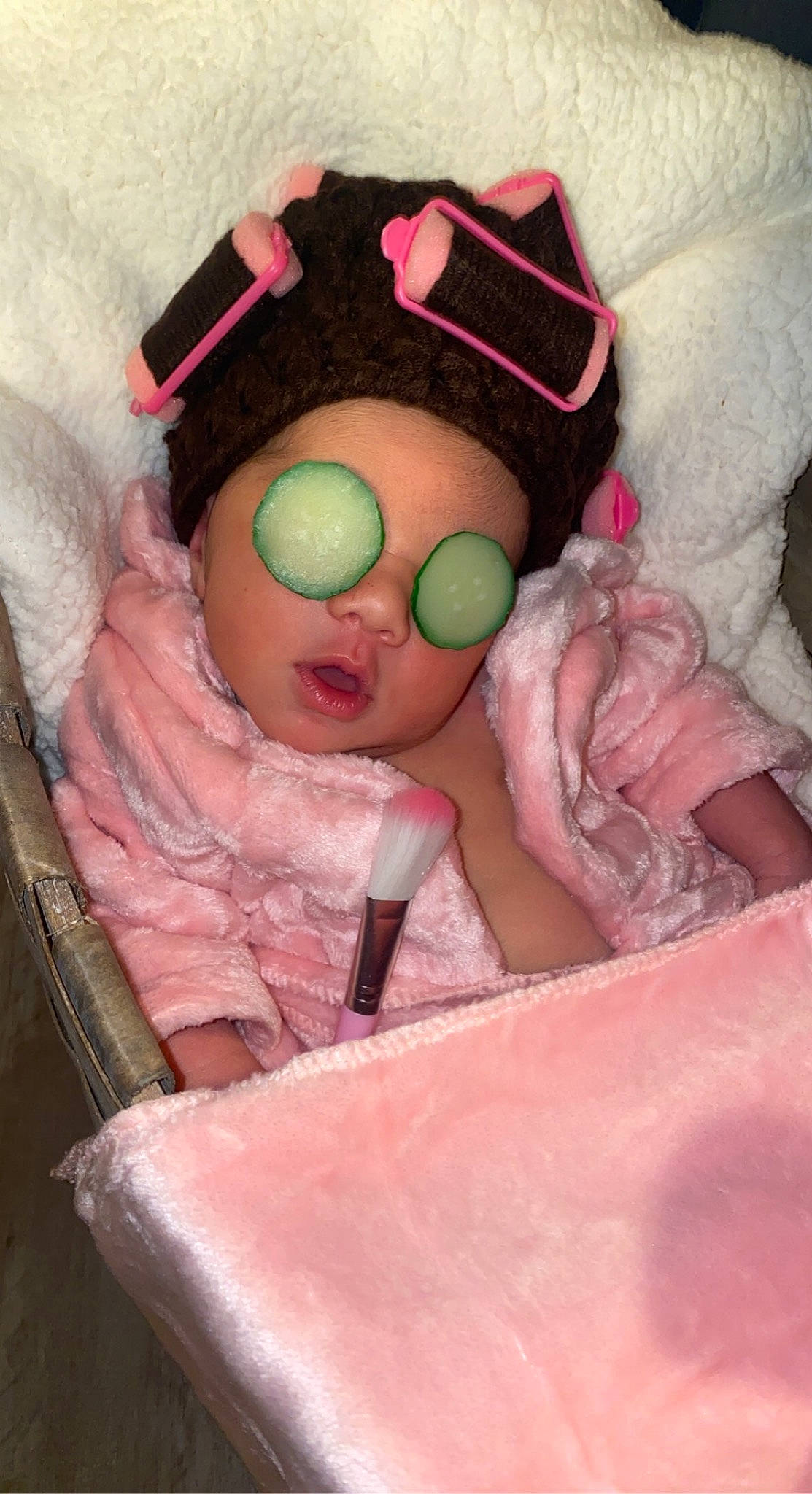 Melania is registered to the contest to win money with this photo: baby, baby_products, baby_safety, baby_toddler_clothing, baby_toys, cheek, comfort, doll, eyewear, head, infant_bed, linens, magenta, mouth, peach, person, pink, plush, stuffed_toy, sunglasses