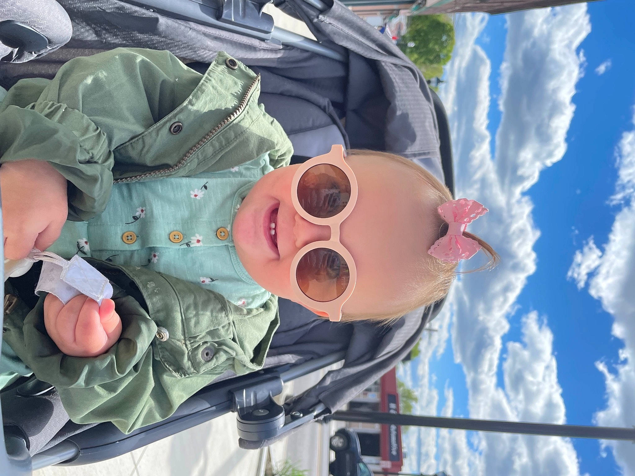 Gracie is registered to the contest to win money with this photo: baby, baby_products, baby_toddler_clothing, child, cloud, comfort, eyewear, gesture, goggles, happy, hat, joy, leisure, mouth, person, skin, sky, smile, sunglasses, toddler