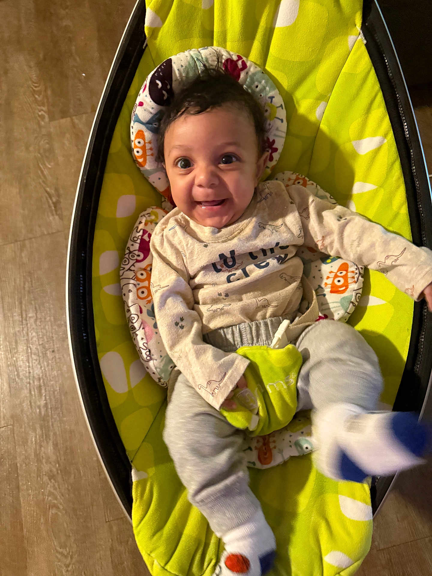 Amin Drummond is registered to the contest to win money with this photo: baby, child, smiling, happy, infant, baby_rocker, clothing, socks, floor, wooden_floor, head, face, seat, cushion, toy, indoor, person, playful, cute, young