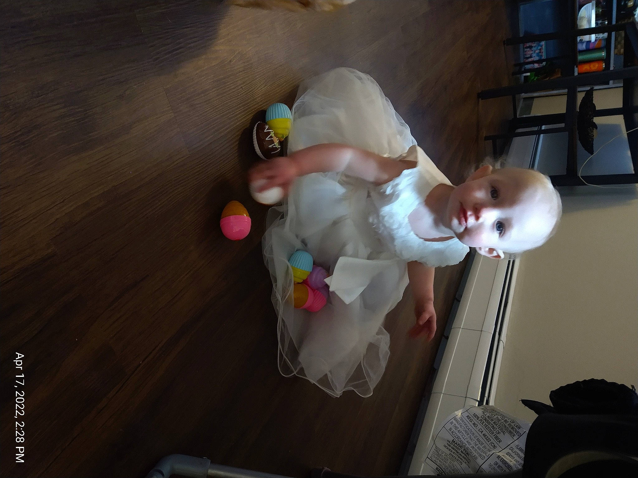 Hazel is registered to the contest to win money with this photo: baby, baby_products, baby_toddler_clothing, baby_toys, child, comfort, flooring, fun, hardwood, home_appliance, person, room, sitting, toddler, wood