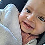 baby, blanket, child, closeup, clothing, cute, expression, eyes, face, happy, head, indoor, infant, portrait, seat, skin, smiling, soft, teeth, warm