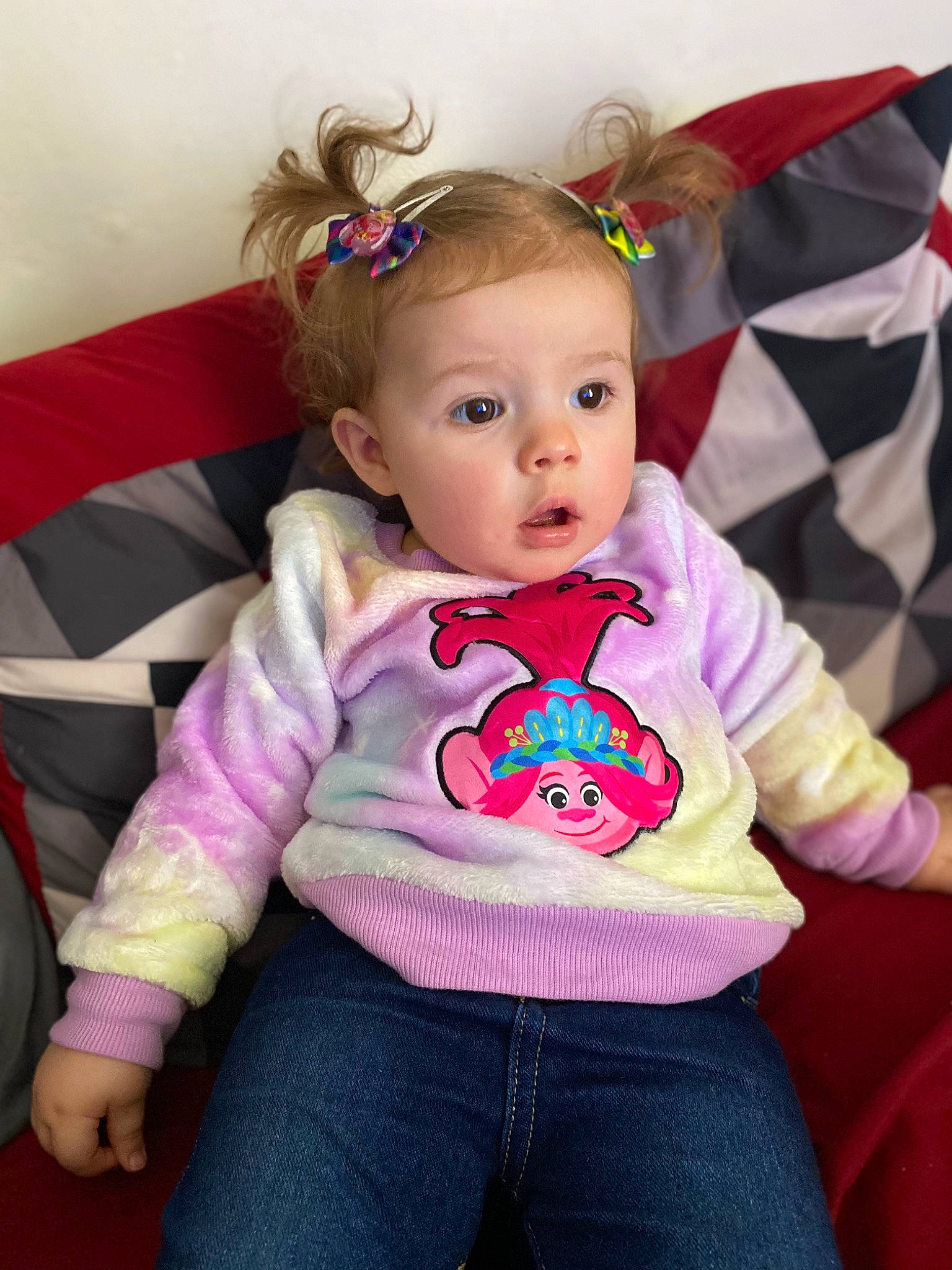 August is registered to the contest to win money with this photo: baby, baby_toddler_clothing, cheek, child, clothing, comfort, fun, grass, happy, headband, jeans, lip, magenta, person, pink, product, purple, sitting, skin, sleeve