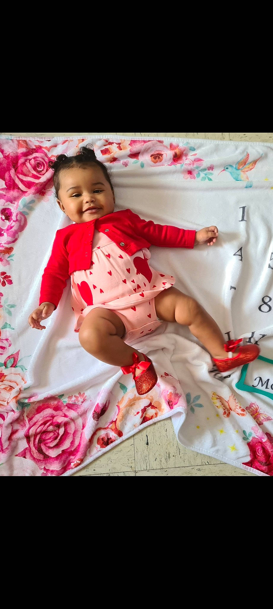 Kamilah is registered to the contest to win money with this photo: arm, baby, baby_toddler_clothing, dress, happy, human_body, joy, leg, linens, magenta, pattern, person, petal, pink, skin, sleeve, smile, sock, t_shirt, textile