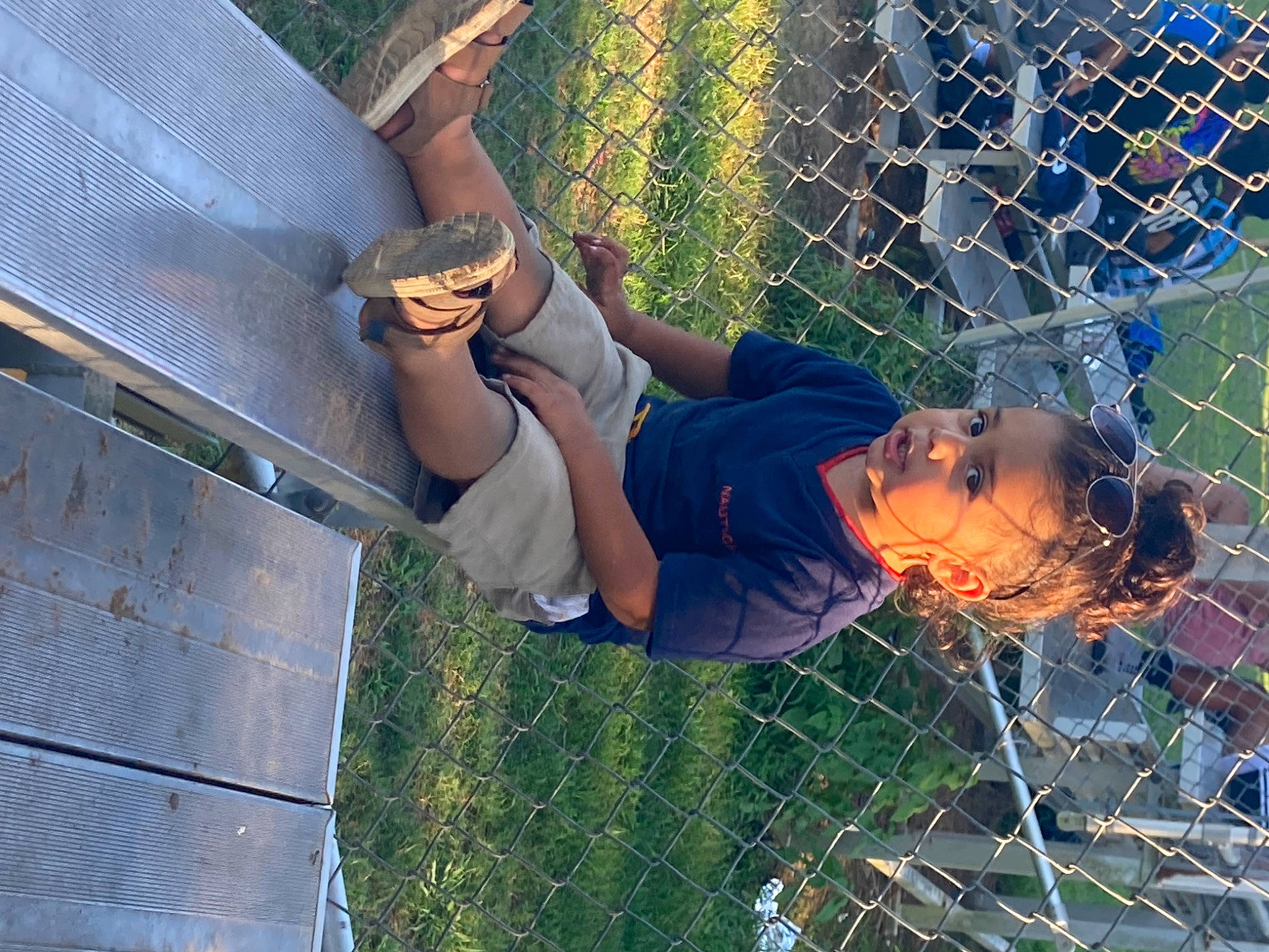 Dereck is registered to the contest to win money with this photo: chain_link_fencing, cool, electric_blue, eyewear, fence, fun, grass, happy, hat, human_leg, leisure, mesh, net, people_in_nature, person, player, recreation, sun_hat, thigh, tree