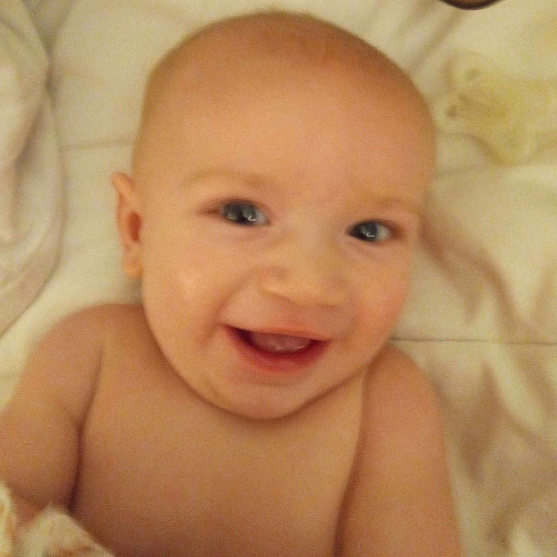 Larson is registered to the contest to win money with this photo: baby, babylaughing, bed, bodypart, cushion, face, furniture, happy, head, homedecor, laughing, mouth, newborn, person, photography, portrait, quilt, selfie, smile, teeth