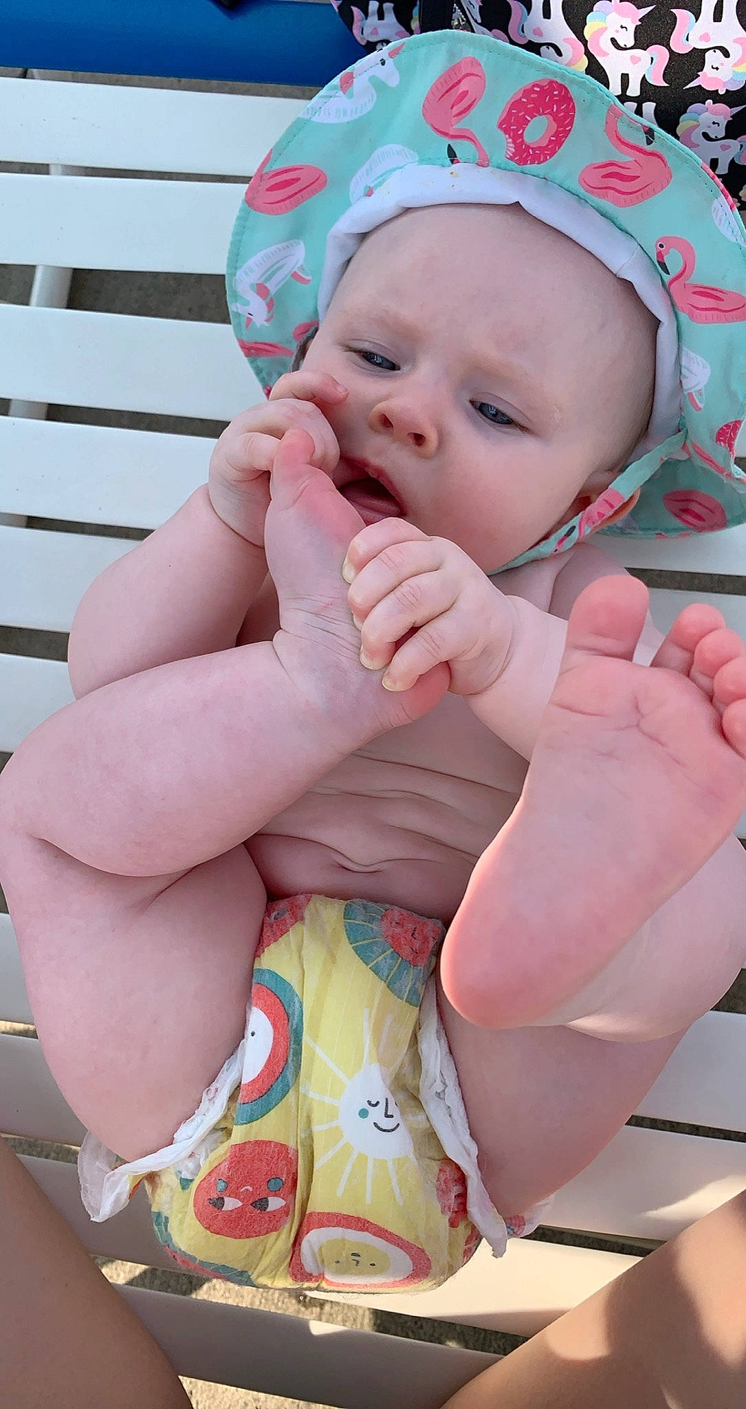 Sophia is registered to the contest to win money with this photo: arm, baby, baby_toddler_clothing, cap, cheek, eye, face, finger, gesture, hand, happy, head, human_body, leg, lip, mouth, nail, nose, person, pink