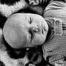 baby, sleeping, infant, blanket, pattern, cozy, clothing, ribbed, fist, peaceful, portrait, closeup, soft, monochrome, black_and_white, newborn, child, resting, cute, indoor