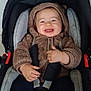 baby, baby_fashion, brown_clothing, car_seat, child, cozy, cute, fuzzy_hoodie, hands, happy, hood, indoor, infant, person, portrait, safety, seatbelt, smiling, toddler, young_child