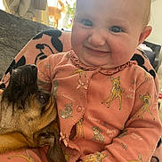 Skyla joined the competition — help win amazing prizes! baby, child, dog, pet, smile, cuddle, onesie, cartoon_print, indoor, cozy, happy, portrait, person, animal, face, hand, window, curtain, blanket, furniture