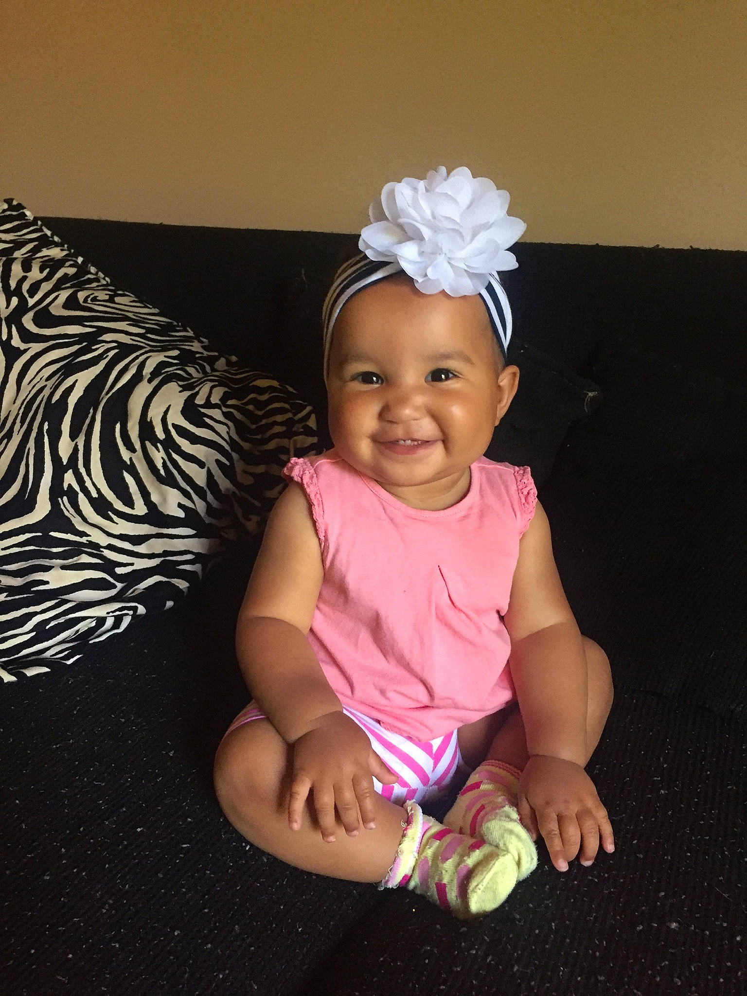 Alaska is registered to the contest to win money with this photo: baby, baby_toddler_clothing, child, costume, costume_accessory, fashion_accessory, fun, hair_accessory, headband, headgear, headpiece, joy, person, pink, sitting, smile, toddler