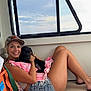 woman, dog, puppy, smile, cap, denim_shorts, pink_towel, bench, window, sky, indoor, relaxing, casual, tattoo, barefoot, orange_bag, phone, summer, pet, happy
