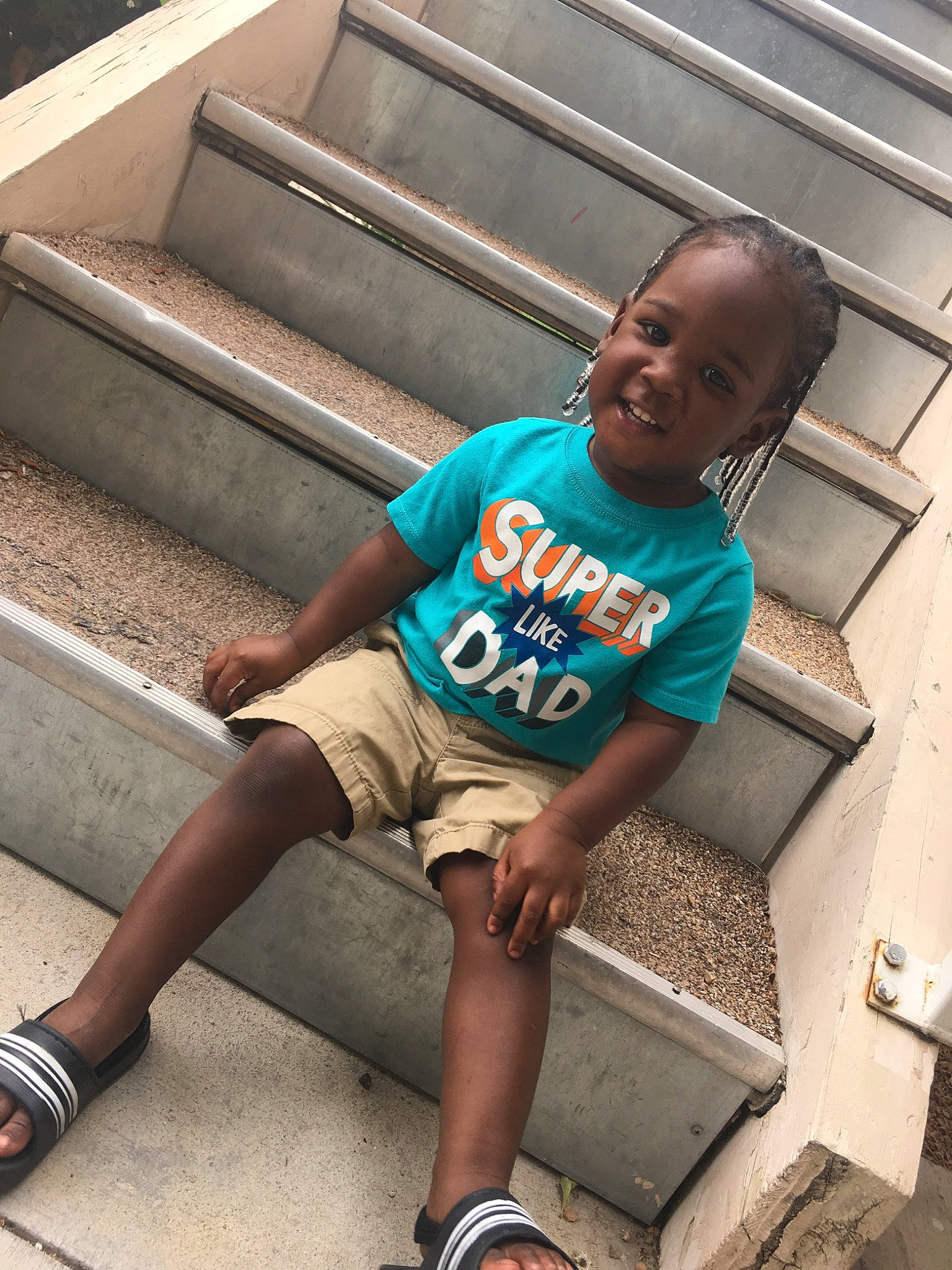 Jamal is registered to the contest to win money with this photo: child, cool, leg, person, sitting, smile, t_shirt