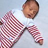 baby, sleeping, infant, striped_clothing, white, red, cozy, peaceful, soft_surface, newborn, cute, child, portrait, lying_down, hands, face, closed_eyes, warm, comfort, knitwear