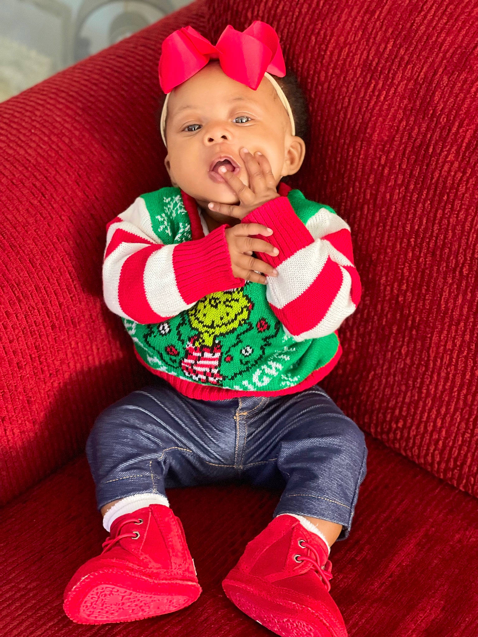 Abiona is registered to the contest to win money with this photo: baby, baby_products, baby_toddler_clothing, carmine, child, christmas, christmas_eve, costume_hat, event, fictional_character, happy, hat, holiday, pattern, person, red, sitting, sleeve, sock, textile
