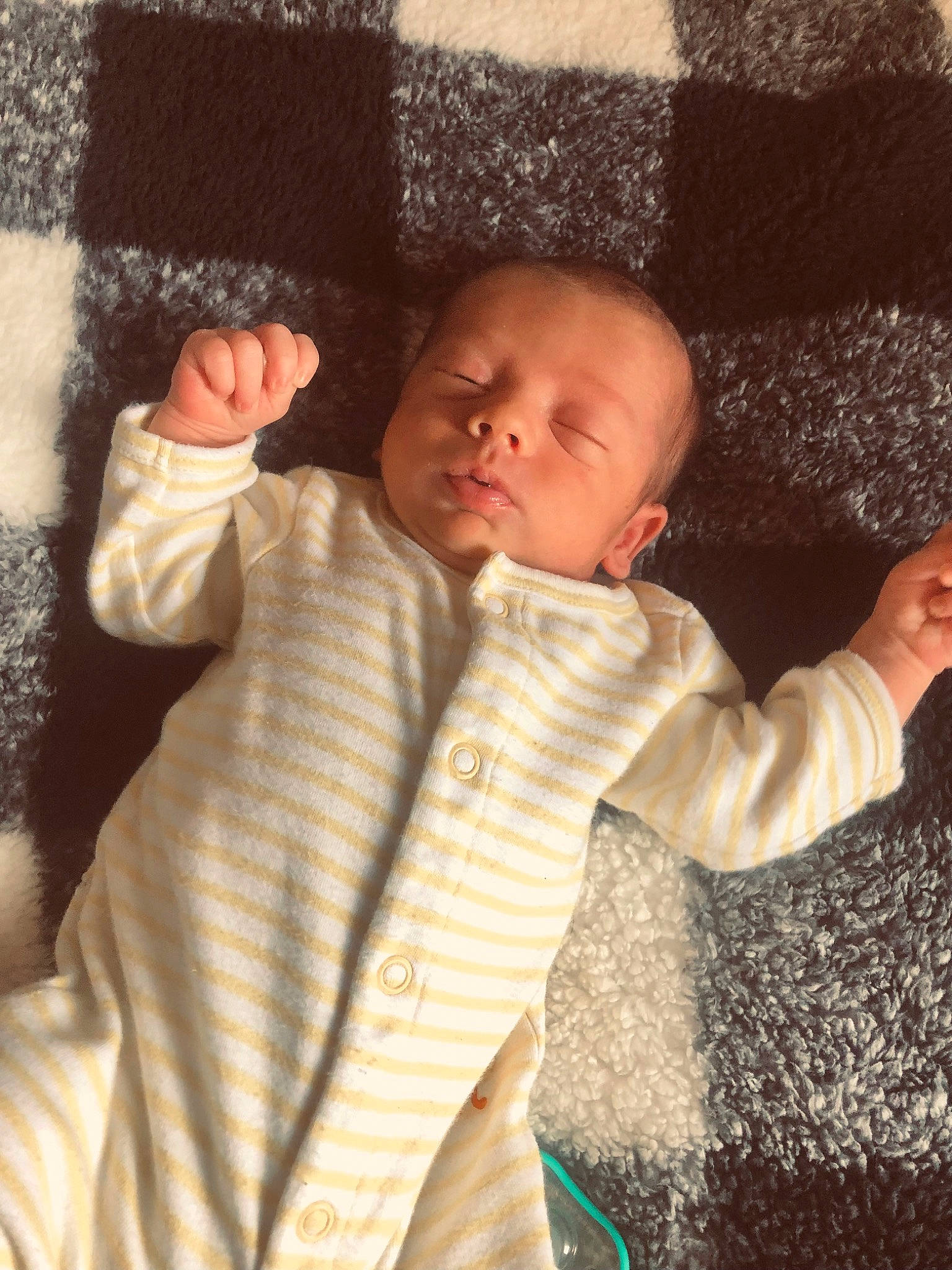 Remington is registered to the contest to win money with this photo: baby, baby_toddler_clothing, brown, cheek, comfort, facial_expression, finger, gesture, head, human, human_body, mouth, nose, outerwear, person, skin, sleeve, standing, textile, thumb