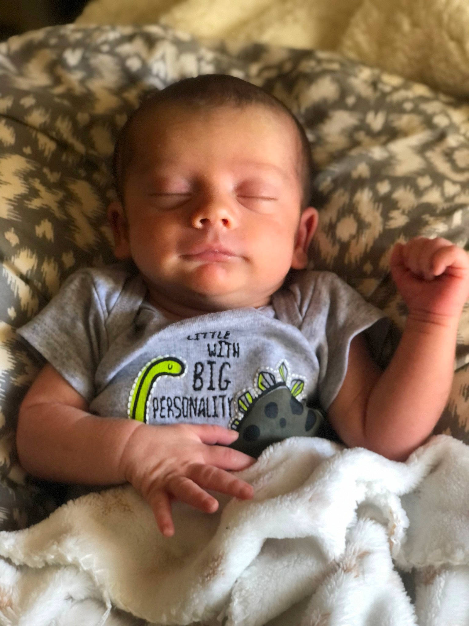 Remington is registered to the contest to win money with this photo: baby, baby_toddler_clothing, cheek, comfort, eye, face, facial_expression, hand, head, human, mammal, mouth, nose, organ, person, photograph, product, skin, sleeve, textile