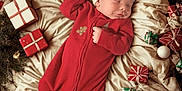 Carsyn joined the competition — help win amazing prizes! baby, sleeping, christmas, holiday, presents, gift_boxes, red_outfit, santa_hat, blanket, evergreen_branches, festive, cozy, infant, holiday_decor, cute, peaceful, indoors, celebration, wrapped_gifts, smiling