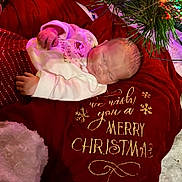 Carsyn is registered to the contest to win money with this photo: baby, newborn, sleeping, blanket, christmas, holiday, festive, red, white, decorations, pine, soft_lighting, cozy, warm, cute, infant, peaceful, clothing, indoors, celebration