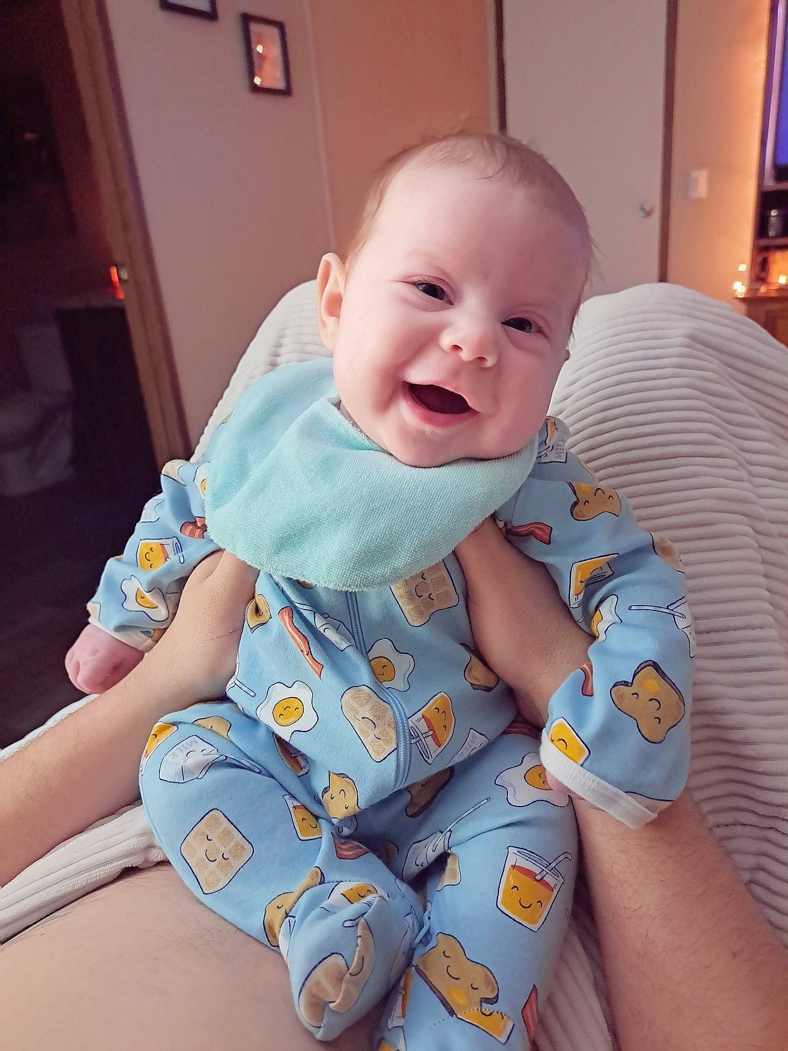 Maddie is registered to the contest to win money with this photo: arm, baby, baby_toddler_clothing, cheek, child, comfort, eye, fun, happy, iris, mouth, person, picture_frame, product, sitting, skin, sleeve, smile, t_shirt, thumb