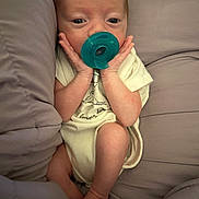 James joined the competition — help win amazing prizes! baby, infant, pacifier, cushion, onesie, hands, face, skin, comfort, soft, sleepy, newborn, cute, small, lying, resting, indoors, child, person, cozy