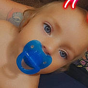 Raven joined the competition — help win amazing prizes! toddler, child, pacifier, blue_eyes, face, close_up, indoor, blanket, couch, skin, digital_filter, devil_horns, baby, portrait, expression, cute, person, light, tattoo, relaxation